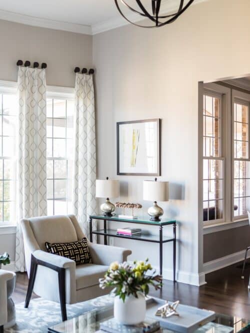 upholstered chair design neutral colors living room beige chair decorative accents side table lamps custom curtains