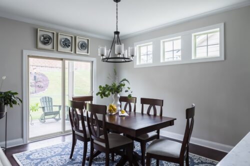 interior design traditional dining room table black metal chandelier blue rug french doors LK Design