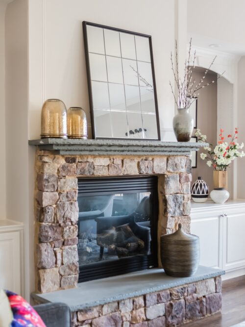 interior design living room stone fireplace built-in shelves art decor accessories