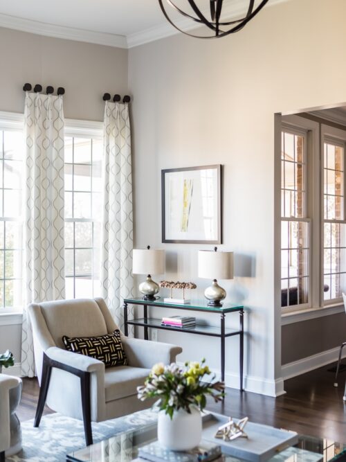 interior design living room white armchair art decor accessories white gray rug glass coffee-table