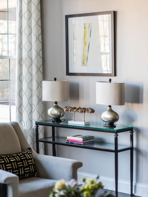 interior design living room white armchair art decor accessories white gray rug glass coffee-table