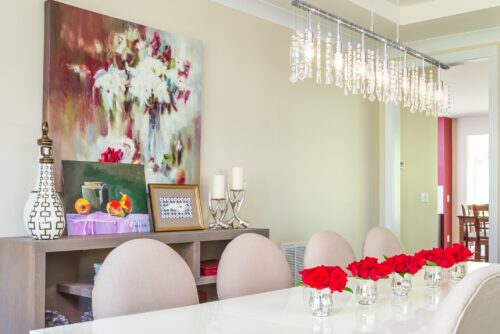 interior design modern dining room white table art collection floral arrangement roses silver candleholders LK Design