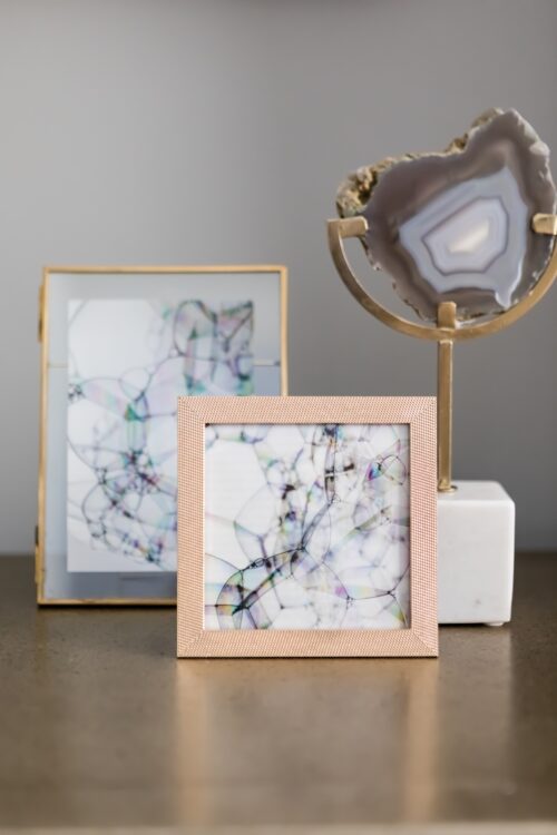 Rose gold frames, magazine photos of bubbles and a decorative crystal