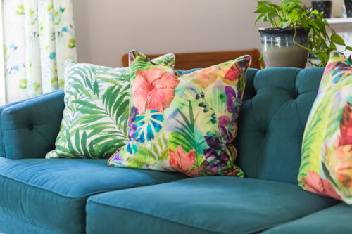 LK Design of Durham living room interior design colorful pillows blue sofa