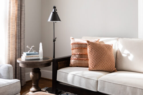 LK Design Home library beige sofa black lamp side tab;e books pillows custom window treatments curtains