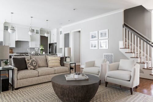 family room interior design open concept transitional style beige sofa white chairs patterned rug wood coffee table