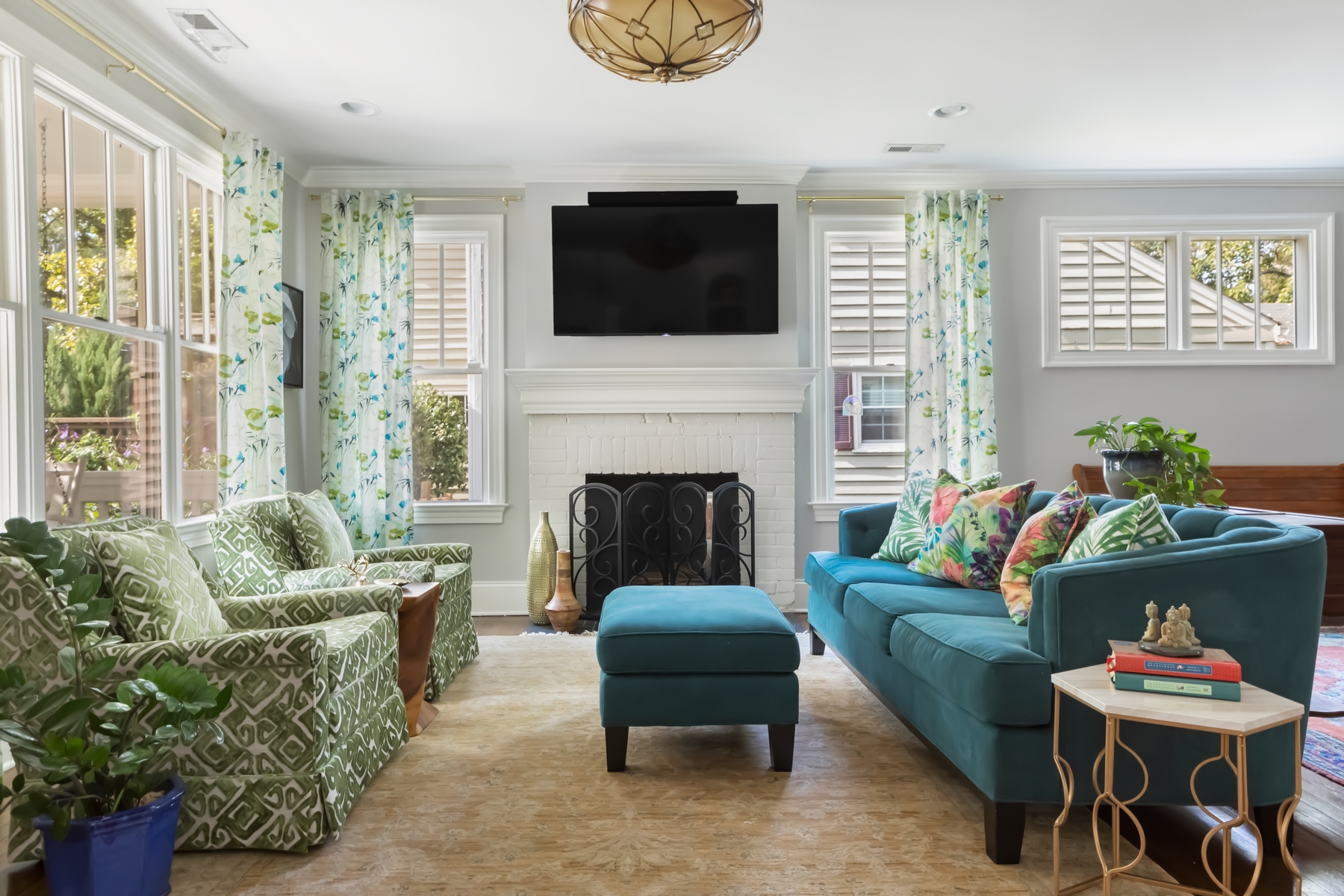 LK Design of Durham living room interior green and blue chairs and sofa and colorful pillows