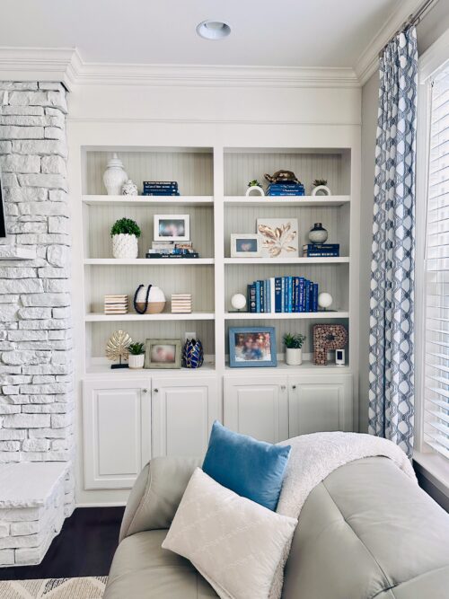 Bright and airy contemporary family room in blues and whites with gorgeous custom window treatments