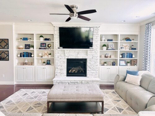 Bright and airy contemporary family room in blues and whites with gorgeous custom window treatments