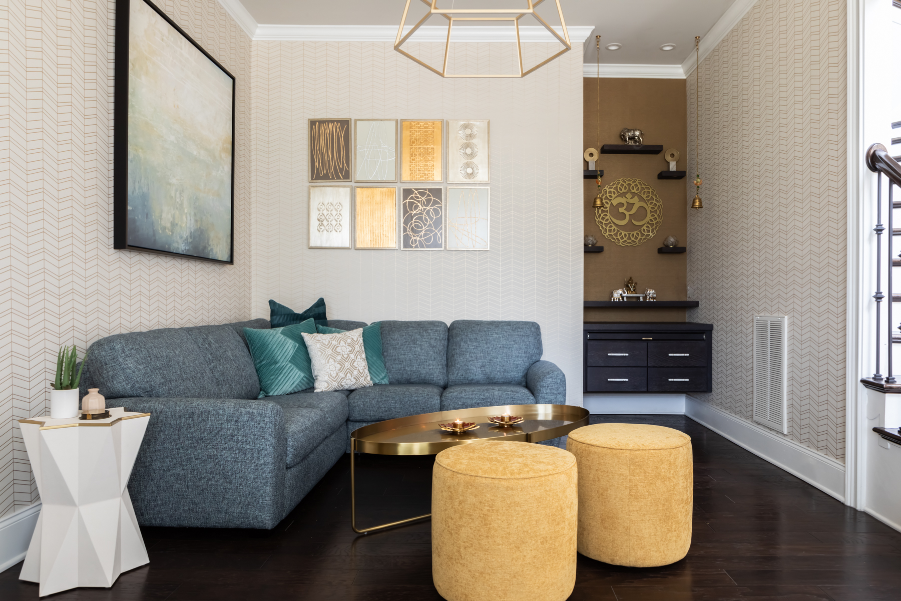 LK design modern living sitting room interior design gold wallpaper blue sectional sofa geometric chandelier yellow ottomans abstract art